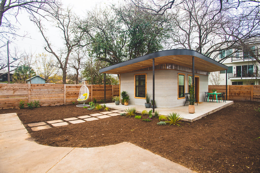 Front and side view of the Icon Labs 3D printed house located in Austin Texas.